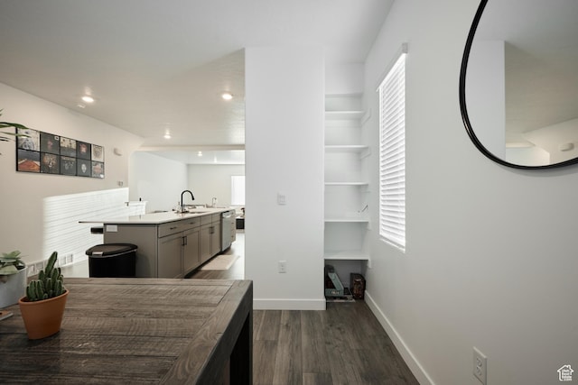 311 S 1130 W Unit 24, American Fork, UT 84003 - kitchen with wood finished floors, baseboards, a sink, a kitchen island with sink, and light countertops
