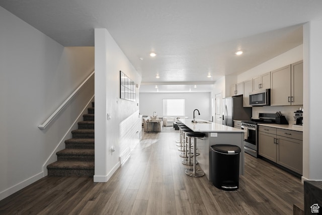 311 S 1130 W Unit 24, American Fork, UT 84003 - kitchen with appliances with stainless steel finishes, a sink, gray cabinetry, a center island with sink, and dark wood finished floors