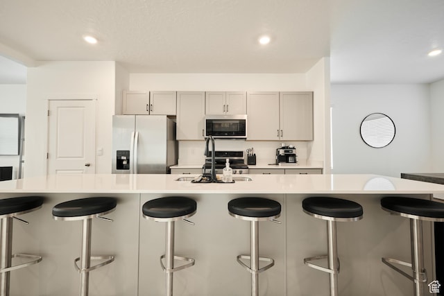311 S 1130 W Unit 24, American Fork, UT 84003 - kitchen with stainless steel appliances, a sink, light countertops, gray cabinetry, and recessed lighting