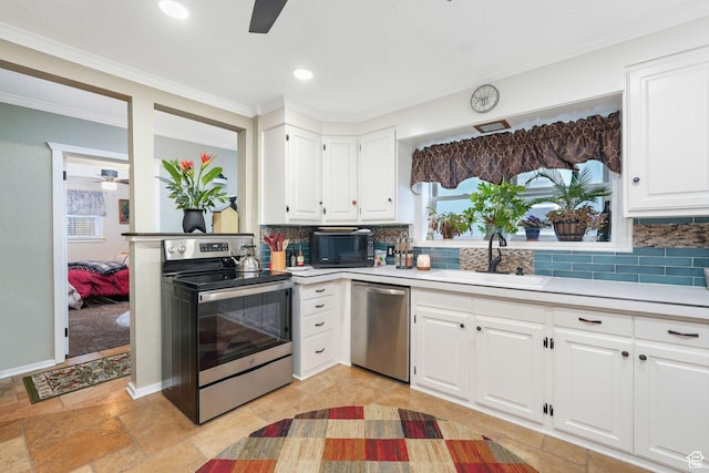 821 E 100 S, Salt Lake City, UT 84102 - kitchen featuring appliances with stainless steel finishes, ceiling fan, a sink, crown molding, and backsplash