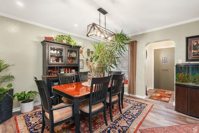 821 E 100 S, Salt Lake City, UT 84102 - dining space with arched walkways, light wood-type flooring, crown molding, and baseboards