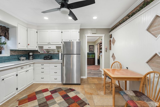 821 E 100 S, Salt Lake City, UT 84102 - kitchen with freestanding refrigerator, ornamental molding, light countertops, stone tile flooring, and tasteful backsplash