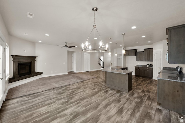 2081 W Jackson Ln, Syracuse, UT 84075 - kitchen with a sink, light stone countertops, dark wood-type flooring, and recessed lighting