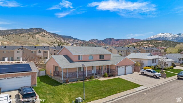 1688 N 175 W, Cedar City, UT 84721 - view of front of home featuring a porch, a residential view, a mountain view, and concrete driveway