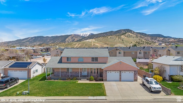 1688 N 175 W, Cedar City, UT 84721 - traditional-style house featuring a residential view, a porch, a garage, a mountain view, and concrete driveway