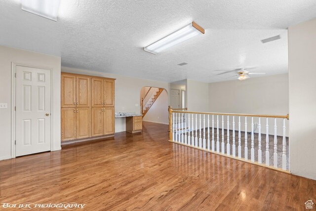 1688 N 175 W, Cedar City, UT 84721 - spare room featuring light wood-type flooring, a ceiling fan, arched walkways, and a textured ceiling