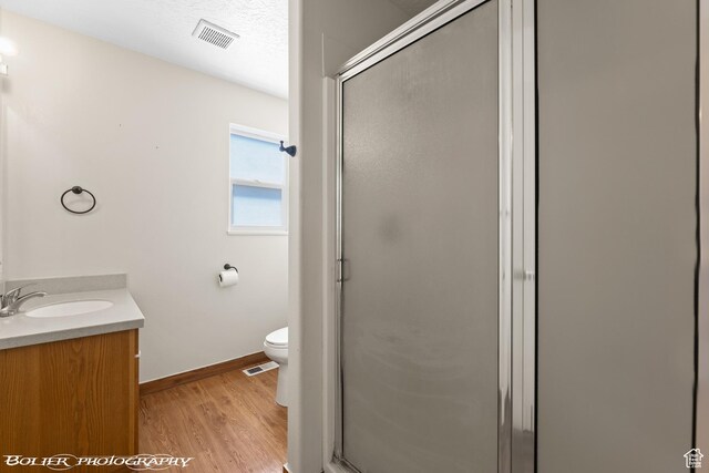 1688 N 175 W, Cedar City, UT 84721 - bathroom featuring wood finished floors, a shower stall, vanity, and toilet