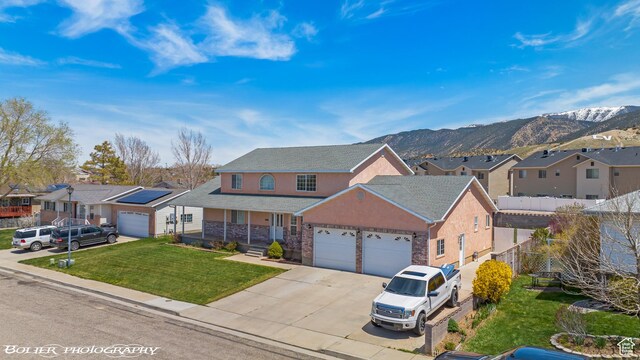 1688 N 175 W, Cedar City, UT 84721 - traditional home featuring a residential view, an attached garage, driveway, and a mountain view
