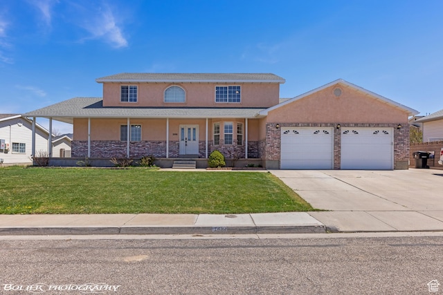 1688 N 175 W, Cedar City, UT 84721 - view of front of property with stucco siding, a garage, driveway, a front yard, and a porch
