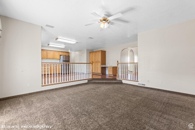1688 N 175 W, Cedar City, UT 84721 - unfurnished living room with ceiling fan, dark colored carpet, and baseboards