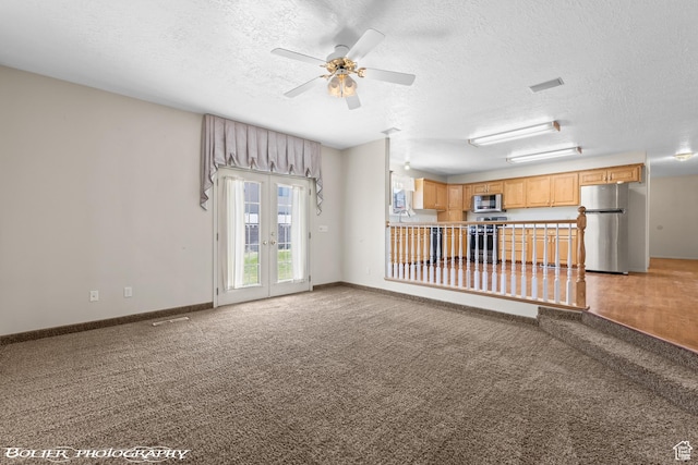 1688 N 175 W, Cedar City, UT 84721 - unfurnished living room featuring a textured ceiling, light colored carpet, ceiling fan, french doors, and baseboards