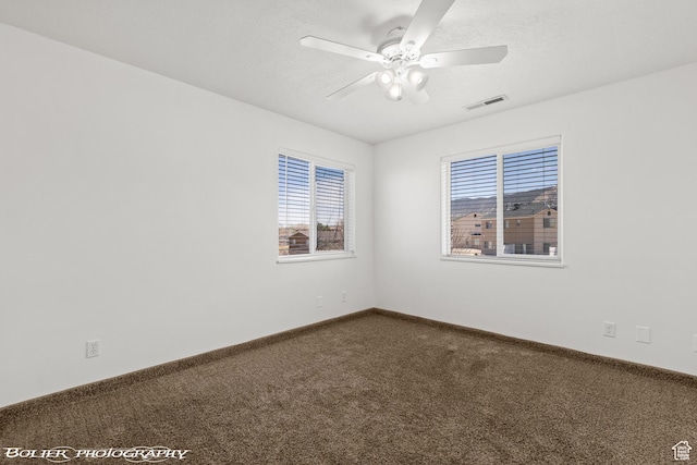 1688 N 175 W, Cedar City, UT 84721 - unfurnished room featuring dark carpet, plenty of natural light, a ceiling fan, and baseboards