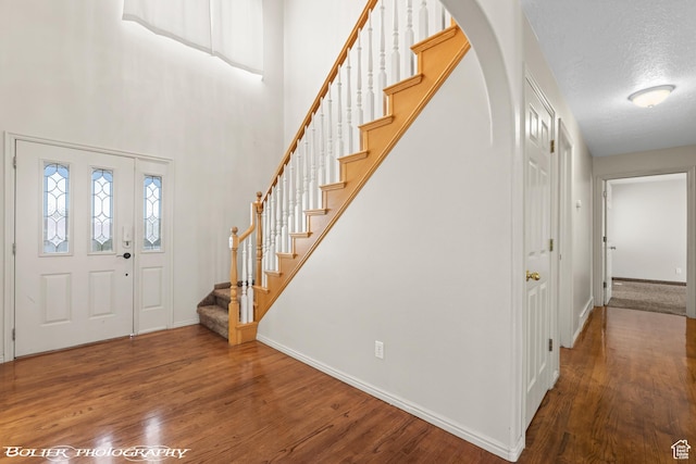 1688 N 175 W, Cedar City, UT 84721 - entryway featuring baseboards, stairs, wood finished floors, arched walkways, and a textured ceiling