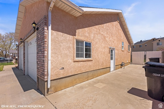 1688 N 175 W, Cedar City, UT 84721 - view of home's exterior featuring stucco siding, an attached garage, fence, driveway, and a patio
