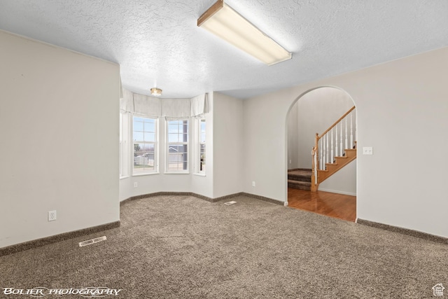 1688 N 175 W, Cedar City, UT 84721 - carpeted spare room with arched walkways, a textured ceiling, stairs, and baseboards