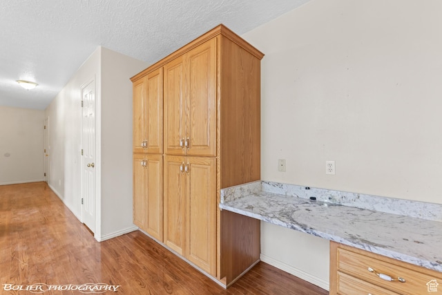 1688 N 175 W, Cedar City, UT 84721 - kitchen with light wood-style floors, light stone countertops, and baseboards