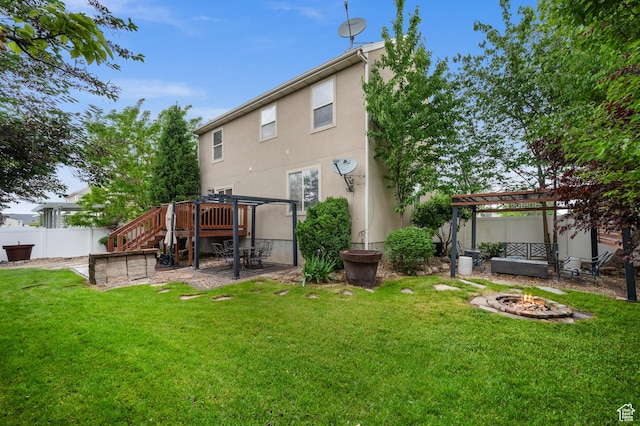 back of house featuring an outdoor fire pit, a pergola, stucco siding, a patio, and stairs