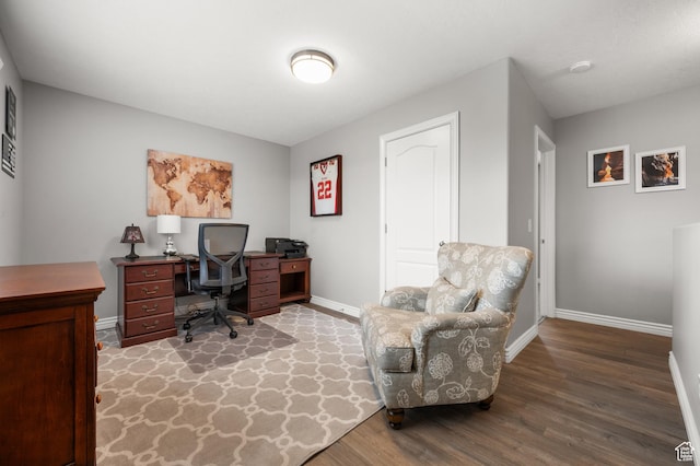 office area featuring baseboards and wood finished floors