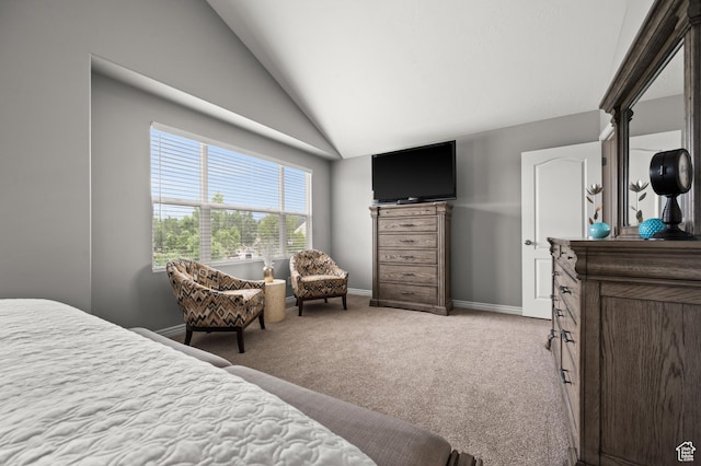 carpeted bedroom with vaulted ceiling and baseboards