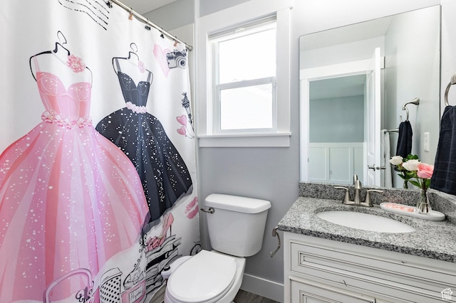bathroom featuring vanity, toilet, and a shower with shower curtain
