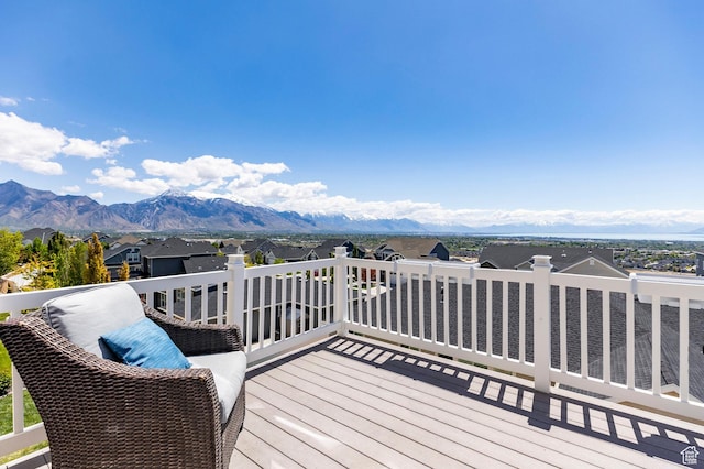 deck with a mountain view and a residential view