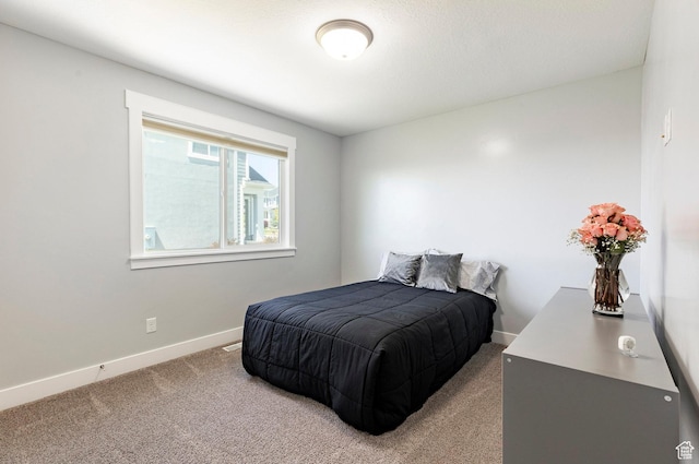 carpeted bedroom with baseboards