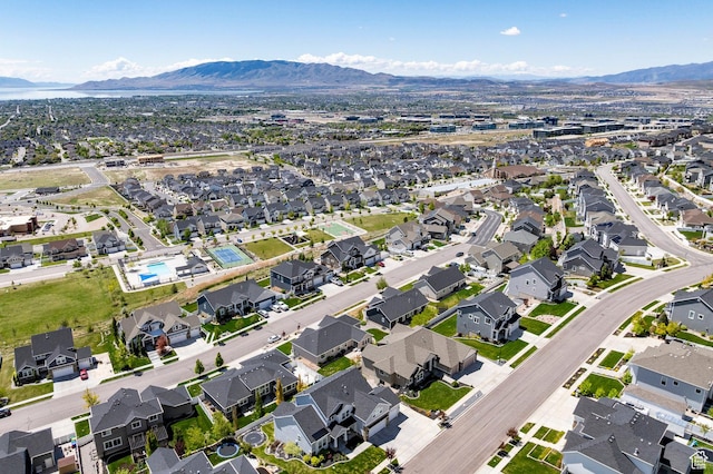 aerial view of property's location featuring a mountain backdrop and nearby suburban area