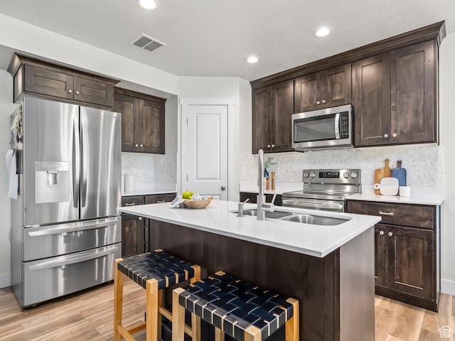 98 E 1040 N Unit 134, Santaquin, UT 84655 - kitchen featuring appliances with stainless steel finishes, dark brown cabinets, light wood-style flooring, light countertops, and recessed lighting