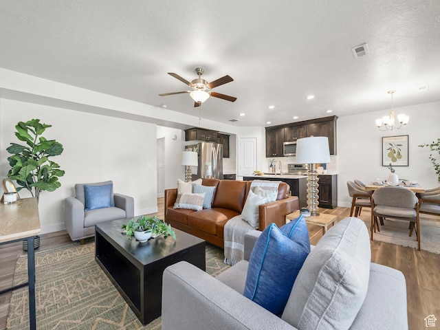 98 E 1040 N Unit 134, Santaquin, UT 84655 - living room featuring a chandelier, baseboards, wood finished floors, ceiling fan, and recessed lighting