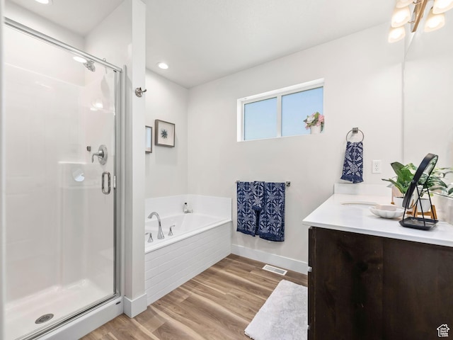 98 E 1040 N Unit 134, Santaquin, UT 84655 - full bathroom featuring vanity, a garden tub, baseboards, a shower stall, and wood finished floors