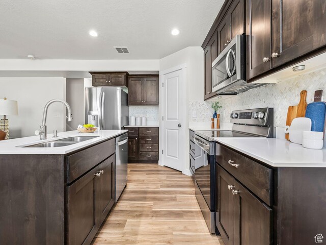 98 E 1040 N Unit 134, Santaquin, UT 84655 - kitchen featuring stainless steel appliances, a sink, light wood-style floors, dark brown cabinets, and light countertops
