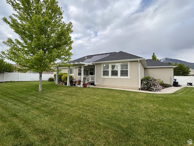 1522 S 1100 E, Spanish Fork, UT 84660 - back of house featuring stucco siding, roof mounted solar panels, and roof with shingles