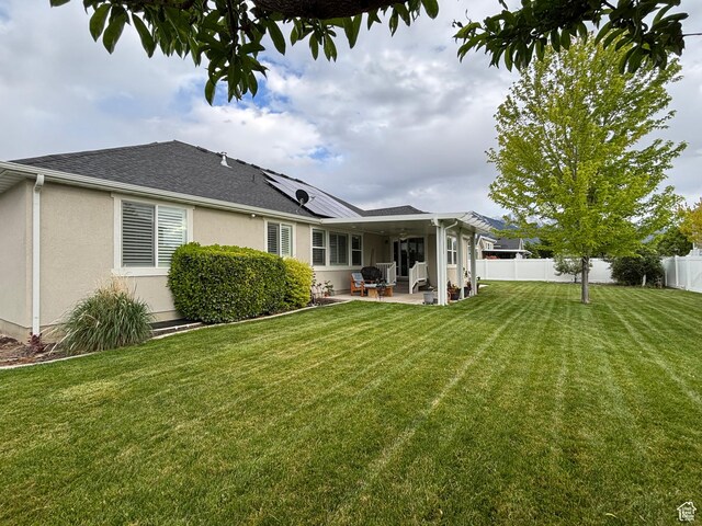 1522 S 1100 E, Spanish Fork, UT 84660 - back of property with a patio, stucco siding, roof mounted solar panels, and a shingled roof