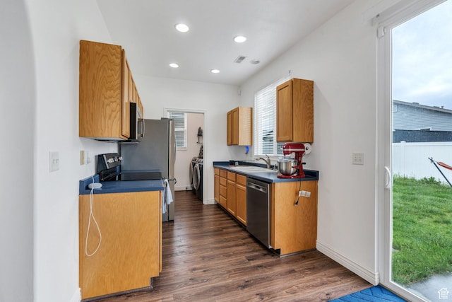 274 N Foxboro Dr, North Salt Lake, UT 84054 - kitchen featuring stainless steel appliances, a sink, washer and clothes dryer, dark countertops, and dark wood-style flooring