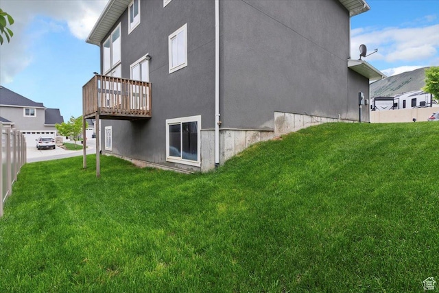 15134 S White Hart Ln, Bluffdale, UT 84065 - view of side of property with a lawn, stucco siding, and a deck