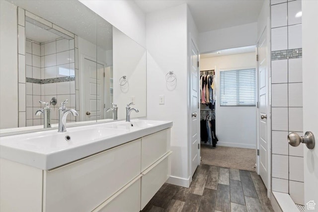 15134 S White Hart Ln, Bluffdale, UT 84065 - bathroom with wood finished floors, double vanity, and a walk in closet