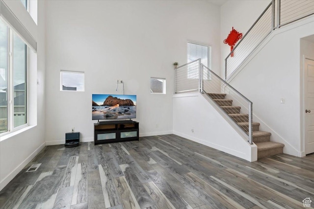 15134 S White Hart Ln, Bluffdale, UT 84065 - living room with a towering ceiling, wood finished floors, stairs, and healthy amount of natural light