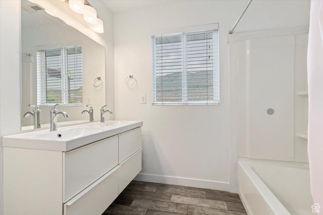 15134 S White Hart Ln, Bluffdale, UT 84065 - bathroom with wood finished floors, double vanity, and bathtub / shower combination