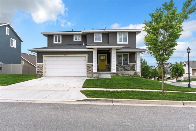 15134 S White Hart Ln, Bluffdale, UT 84065 - view of front of property featuring concrete driveway, stone siding, an attached garage, and covered porch