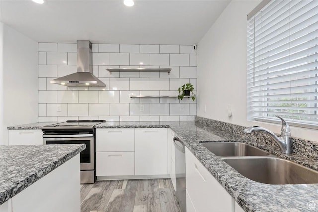 15134 S White Hart Ln, Bluffdale, UT 84065 - kitchen featuring wall chimney range hood, appliances with stainless steel finishes, dark stone countertops, white cabinetry, and tasteful backsplash