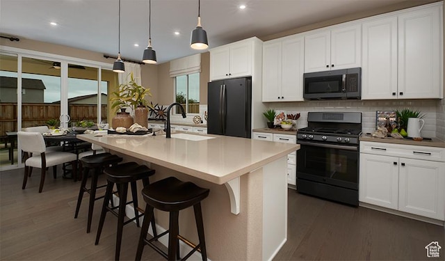 1083 W 400th St S Unit 42, Brigham City, UT 84302 - kitchen featuring gas range oven, freestanding refrigerator, a sink, tasteful backsplash, and dark wood-type flooring