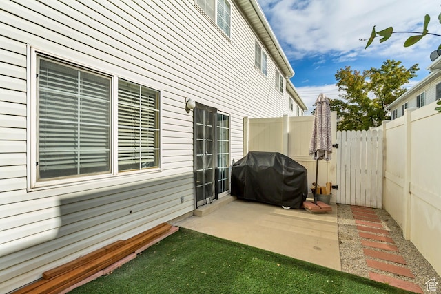 view of patio / terrace with a grill and fence