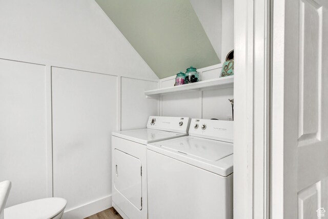 washroom featuring washing machine and dryer and light wood-type flooring
