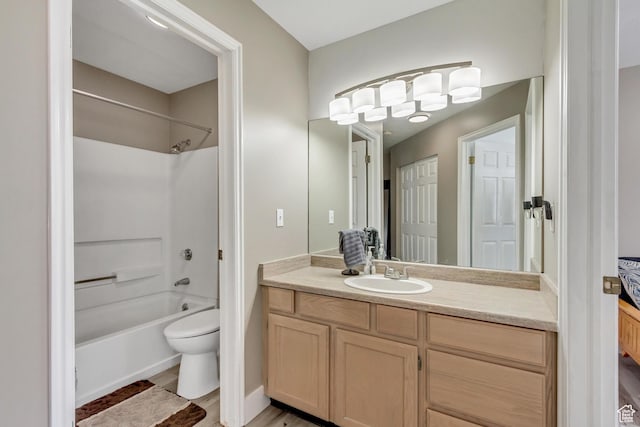 full bathroom with vanity, shower / bathtub combination, toilet, and wood finished floors