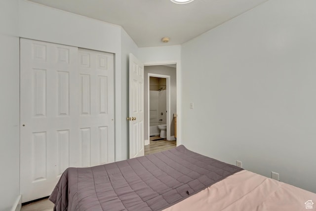 bedroom with wood finished floors and a closet