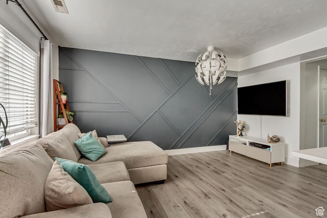 living room featuring a decorative wall and wood finished floors
