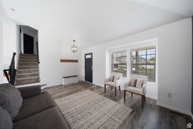 6507 S Silver Medal Dr, Taylorsville, UT 84129 - living area featuring wood finished floors, vaulted ceiling, baseboards, and a chandelier