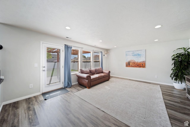 6507 S Silver Medal Dr, Taylorsville, UT 84129 - living area featuring wood finished floors, baseboards, and recessed lighting