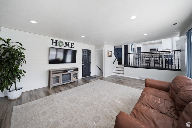 6507 S Silver Medal Dr, Taylorsville, UT 84129 - living area featuring wood finished floors, recessed lighting, baseboards, and stairs