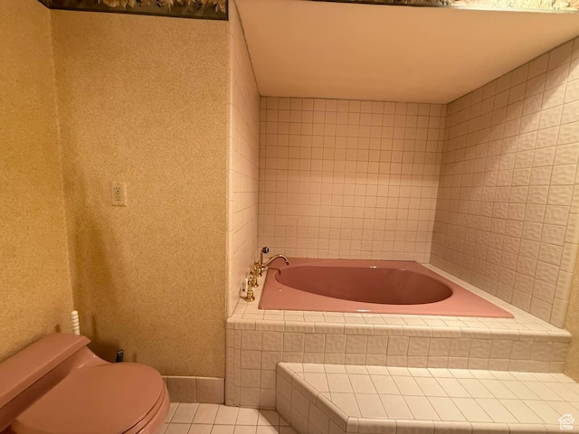 full bath featuring tile patterned flooring, toilet, and a bath